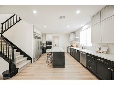 Modern kitchen with stainless steel appliances and large island at 5865 Wildhorse Ledge Ave, Las Vegas, NV 89131