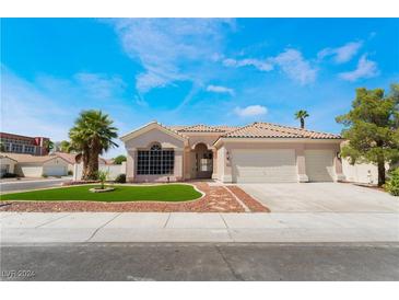 Single-story house with a two-car garage and landscaped front yard at 8644 Highland View Ave, Las Vegas, NV 89145