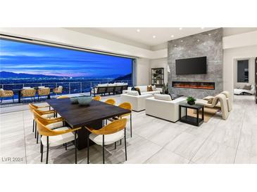 Luxury living room boasts city views, fireplace, and ample seating at 661 Ridgestone Rim Ct, Henderson, NV 89012