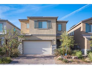 Curb appeal abounds at this two-story home featuring a neutral color palette and attached garage at 3746 Bright Aquarius Ln, Henderson, NV 89052