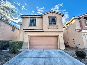 Two-story house with attached garage and landscaping at 5255 Cedar Bend Dr, North Las Vegas, NV 89031