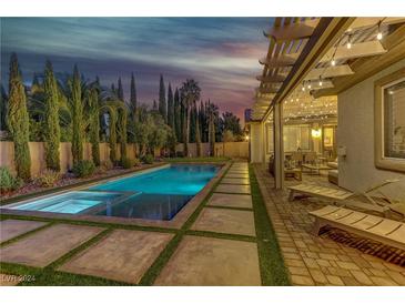 Stunning pool and patio area with a pergola, lounge chairs, and outdoor dining at 5434 Pendini Point Ct, Las Vegas, NV 89141