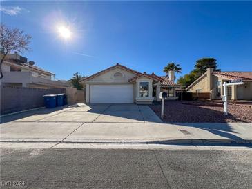 Single story home with attached garage and desert landscaping at 1275 White Dr, Las Vegas, NV 89119