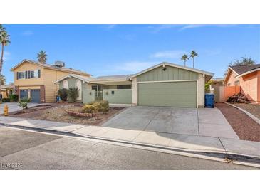 Ranch style home with a two-car garage and well-manicured landscaping at 3951 Avonwood Ave, Las Vegas, NV 89121