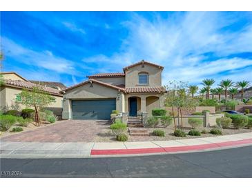 Two-story house with gray garage door and landscaped yard at 2 Vicolo Verdi, Henderson, NV 89011