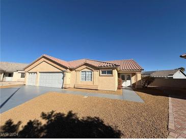 Single-story house with a three-car garage and desert landscaping at 5236 Zebra Ct, North Las Vegas, NV 89031