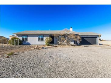 Ranch style home with gray exterior, gravel driveway, and a two car garage at 436 Emden St, Henderson, NV 89015