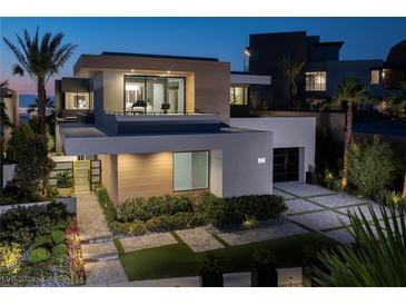 Modern two-story home with landscaped grounds and a two-car garage at dusk at 1096 Spirit Rock Dr, Henderson, NV 89012