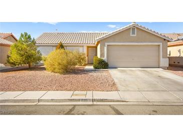 One-story house with a two-car garage and well-manicured landscaping at 2135 Prevail Dr, North Las Vegas, NV 89032