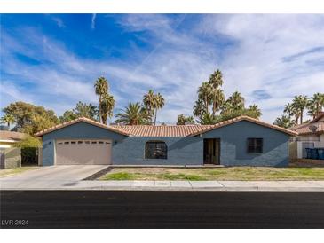 Ranch style home with attached two-car garage and desert landscaping at 3850 Pacific St, Las Vegas, NV 89121