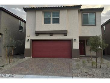 Two-story house with red garage door and brick driveway at 6132 Vista Teal Ln # Lot 21, Las Vegas, NV 89115