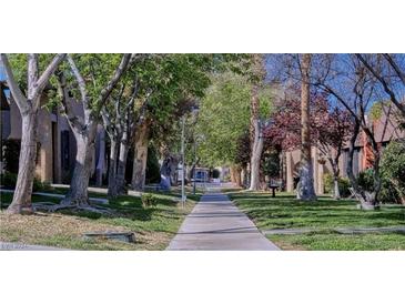 Paved pathway winds through a tree-lined community at 4622 Grand Dr # 1, Las Vegas, NV 89169