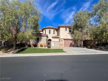 Two-story house with stone accents and a three-car garage at 2152 Pont National Dr, Henderson, NV 89044