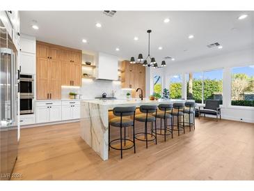 Gourmet kitchen boasts modern cabinetry, expansive island, and high-end appliances at 1391 Quiet River Ave, Henderson, NV 89012