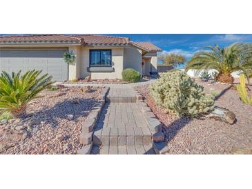 Front view of a single-story house with a landscaped yard and walkway at 188 Beach Oak Ave, Henderson, NV 89002