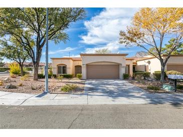 Single-story house with a two-car garage and landscaped front yard at 2705 Vista Butte Dr, Las Vegas, NV 89134