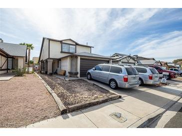 Two-story house with attached garage and driveway, ample parking at 522 Crony Ave, Henderson, NV 89011