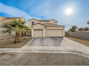 Two-story home with attached two-car garage and desert landscaping at 5905 Reflection Point Ct, Las Vegas, NV 89110