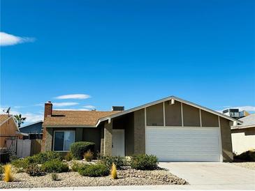 Single story home with landscaped front yard and attached garage at 616 Sportsman Dr, Las Vegas, NV 89107