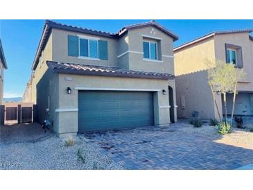 Two-story house with a green door and a brick driveway at 8279 Palladium St, Las Vegas, NV 89113