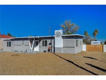 Charming single story home with a gray exterior and well-manicured front yard at 1829 Sweeney Ave, Las Vegas, NV 89104