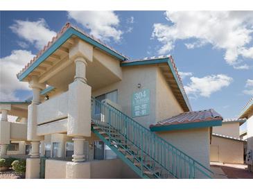 Building exterior with teal accents and staircase at 304 S Buffalo Dr # 201, Las Vegas, NV 89145