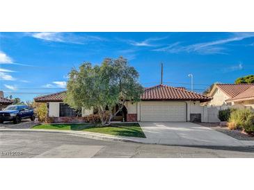 Single-story home with a tile roof and attached two-car garage at 5423 Arturo Ct, Las Vegas, NV 89120