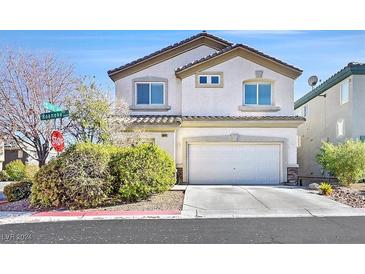 Two-story house with attached garage and well-maintained landscaping at 6678 Roanoke Ct, Las Vegas, NV 89148