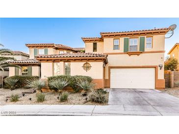 Two-story house with beige exterior, green shutters, and landscaping at 7293 Iron Oak Ave, Las Vegas, NV 89113