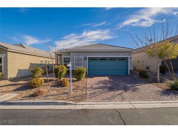 Single-story home with teal garage door and landscaped front yard at 8054 Tulip Bulb St, Las Vegas, NV 89113