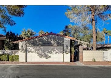 Single-story home with attached garage and well-maintained landscaping at 3012 Plaza De Rosa, Las Vegas, NV 89102