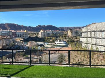 Stunning view of lake, mountains, and community from private balcony at 42 Promenade Isle Ln, Henderson, NV 89011