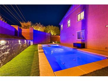 Stunning pool with integrated spa at night at 10590 Sturdevant Ct, Las Vegas, NV 89166