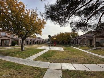 Community playground and green space surrounded by townhouses at 2521 Sierra Luna Ave # 106, Las Vegas, NV 89106