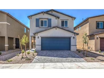 Two-story house with gray siding, blue garage door, and landscaping at 812 Rancho Sedona Ave # Lot 21, North Las Vegas, NV 89081