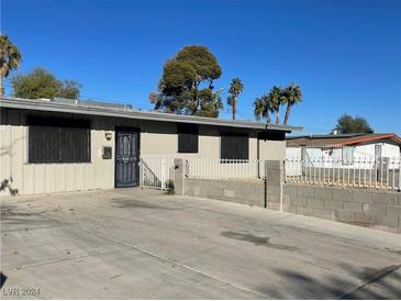 Ranch style home with a large front yard and a driveway at 1812 Ryan Ave, Las Vegas, NV 89101