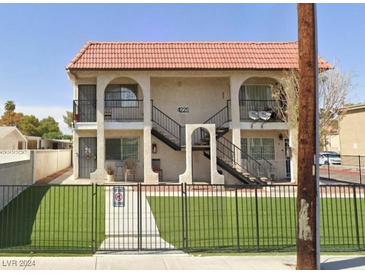 Two-story building with a red tile roof and a fenced yard at 4225 Stewart Ave, Las Vegas, NV 89110