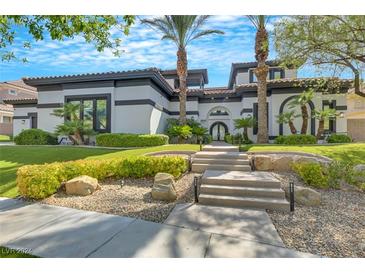 Stunning two-story home with a landscaped front yard and palm trees at 1529 Villa Rica Dr, Henderson, NV 89052