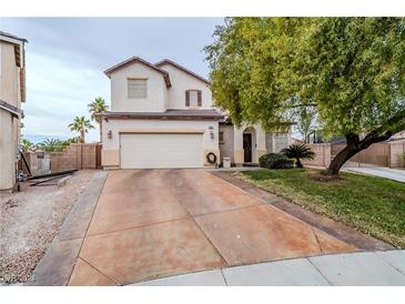 Two-story home with attached garage, driveway, and front yard landscaping at 2939 Cafe Racer Ct, North Las Vegas, NV 89031