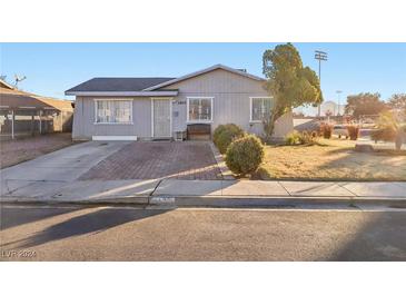 Ranch style home with front yard landscaping and a brick driveway at 3400 Landau St, North Las Vegas, NV 89030