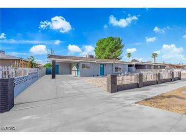 Newly renovated single-story home with teal door and gravel driveway at 525 Wyatt Ave, Las Vegas, NV 89106