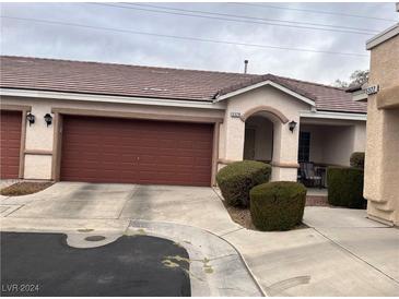 Front view of charming house with attached garage and well-manicured landscaping at 5328 Cholla Cactus Ave, Las Vegas, NV 89141