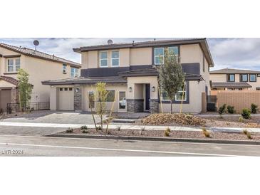 Two-story house with attached garage and landscaped front yard at 1125 Green Lovebird St # 550, Henderson, NV 89011