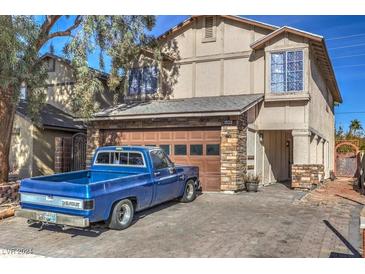 Two-story house with a two-car garage and a landscaped yard at 4200 Tolkien Ave, Las Vegas, NV 89115