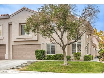 Tan two-story house with attached garage and landscaping at 509 Crepes Pl, Henderson, NV 89052