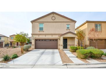 Two-story house with brown garage door and landscaping at 4959 Quest Tribe St, Las Vegas, NV 89122