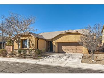 Single-story home with attached garage and landscaping at 6717 Journey Hills Ct, North Las Vegas, NV 89084