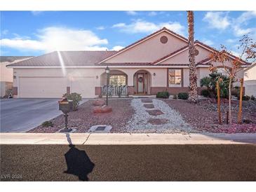 Beautiful desert home with 3 car garage, mature landscaping, and inviting front porch at 7301 Bachelors Button Dr, Las Vegas, NV 89131