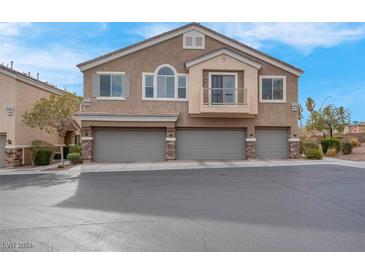 Two-story townhome with attached two-car garage and balcony at 9165 Goose Lake Way # 103, Las Vegas, NV 89149