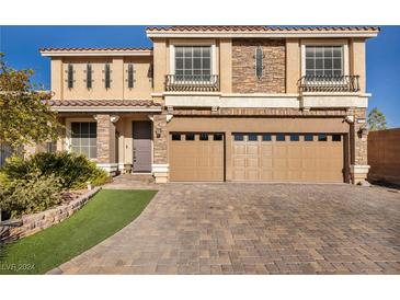 Inviting two-story home with a paved driveway, attached two-car garage, and a neatly landscaped front yard at 5728 Collier Falls Ave, Las Vegas, NV 89139